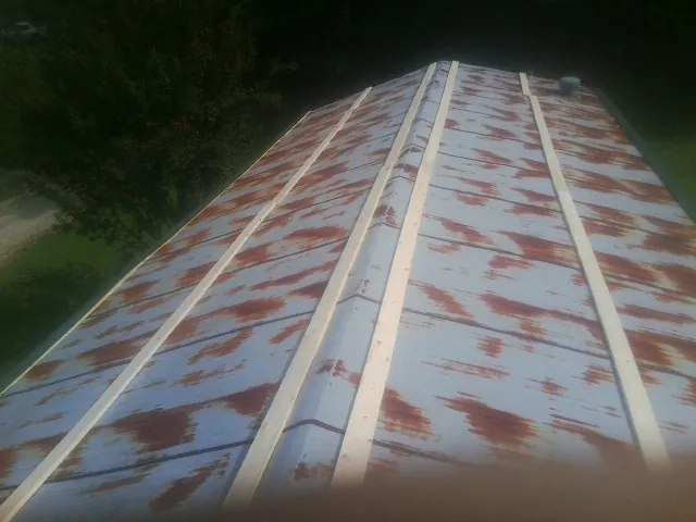 Rusted metal roof panels with new wood purlins before replacement — Storm Damage Roof Repair in South Plainfield by Roofing Brothers