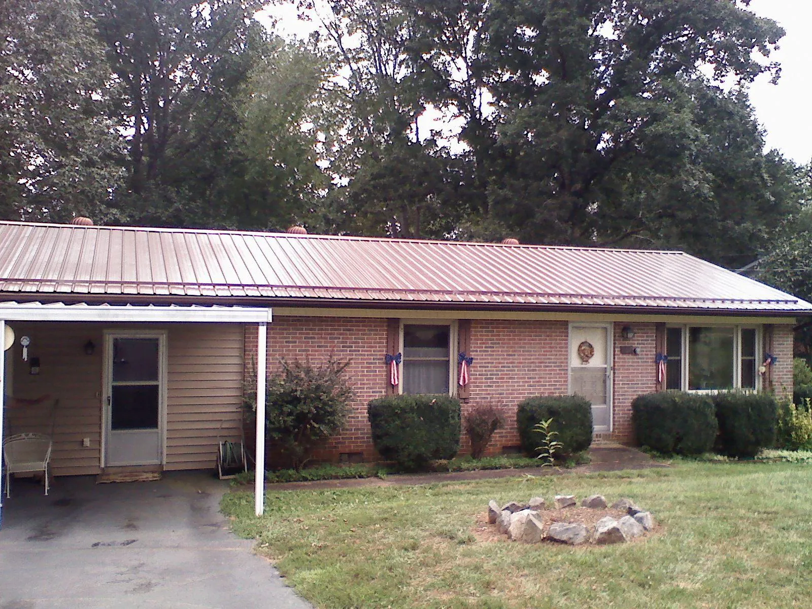 Bronze metal roof and carport on a brick ranch home — Roof Repair work by our crew in South Plainfield