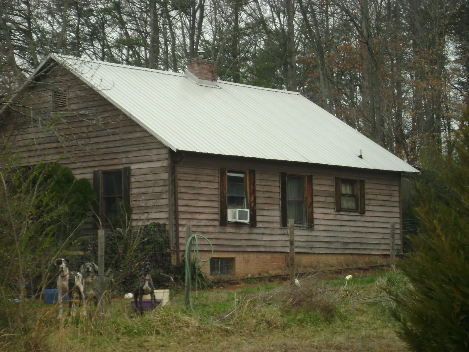 White metal roof on an old wood sided farmhouse, from a Asphalt Shingle Roof Repair job in South Plainfield